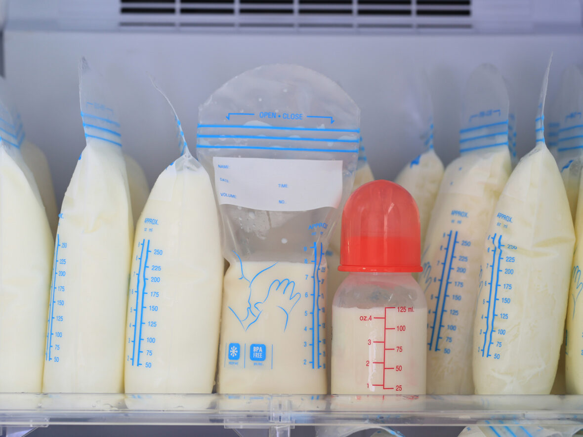 A variety of plastic bags containing breast milk nestled within a fridge