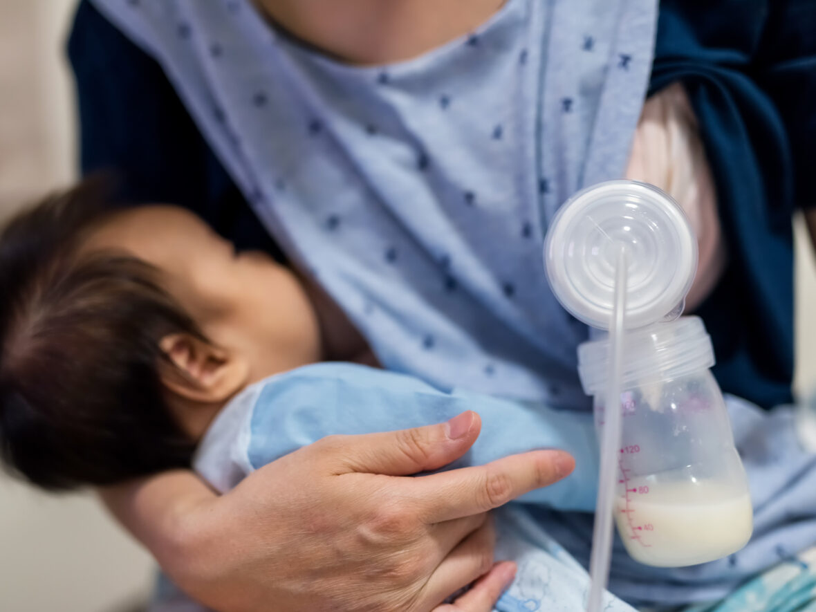 A woman breastfeeding her newborn son